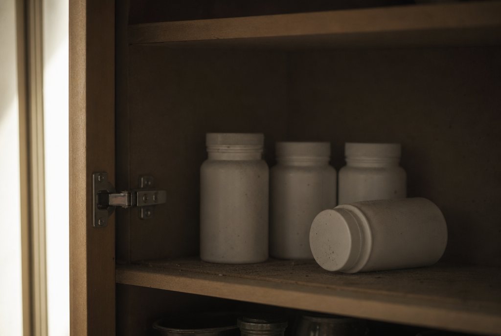 Abandoned supplement bottles at the back of a cupboard